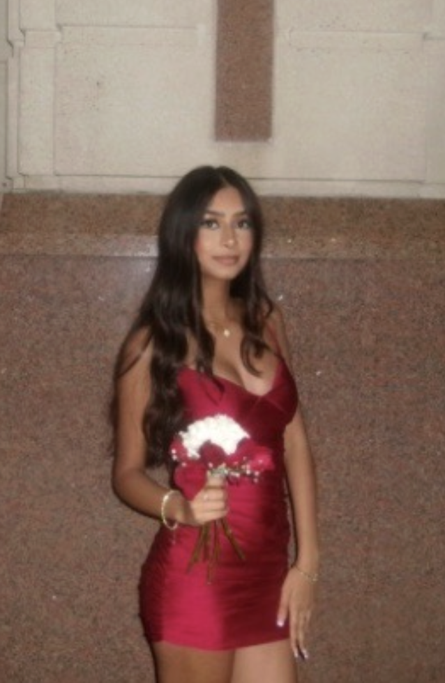 Pragna in red dress holding flowers